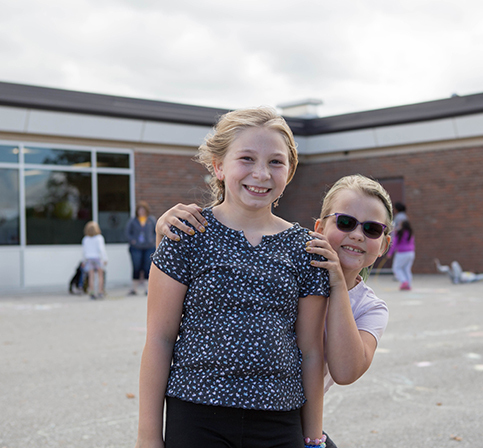 KHPS Alpine Feature1 060223 two young female students outside of building