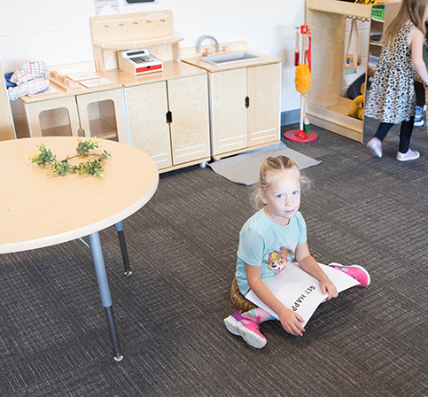 KHPS ECC Feature2 060223 female student reading on the floor